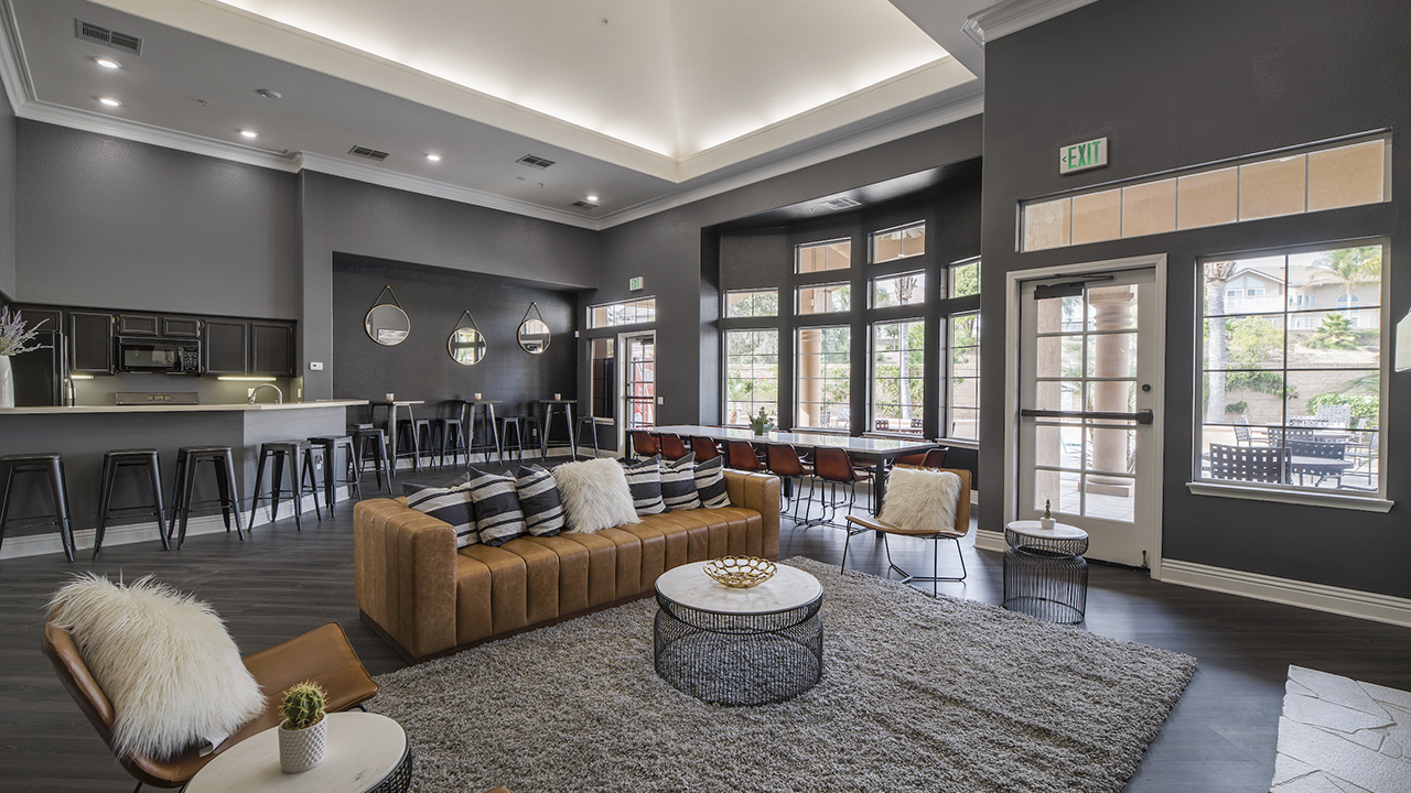 Cozy Clubroom with a sofa, lounge chairs, a breakfast bar, and bar seating