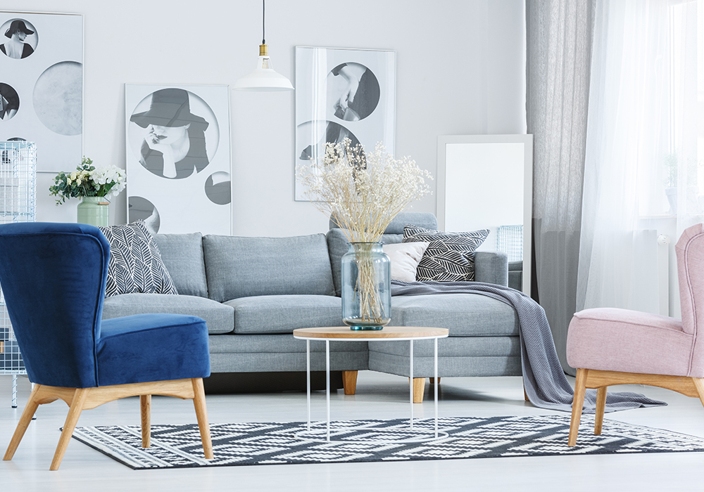 Light and airy staged living room featuring blue, gray, and pink furniture