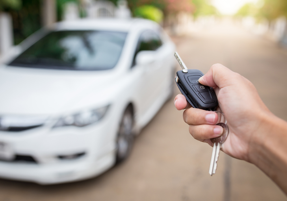 Car keys with a blurred white car in the background
