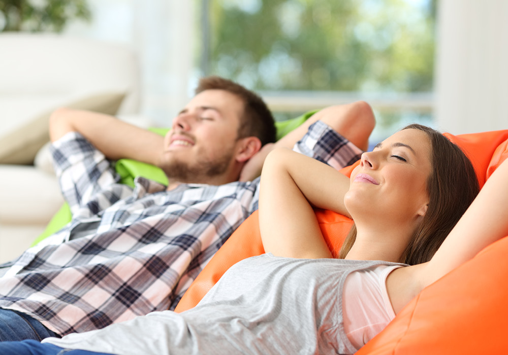 Couple relaxing in their apartment home.