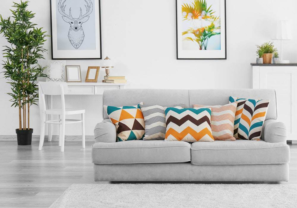 Staged apartment living room featuring couch.