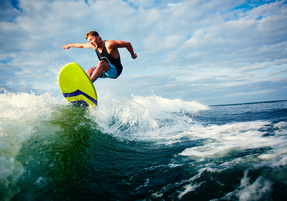 Man riding a wave on his surfboard.